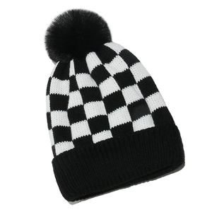Winter checkered knit beanie with a faux fur pom-pom and thick fleece lining in black and white