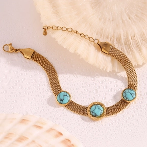 Detail of 18K gold plated mesh bracelet with turquoise stones and seashell decor