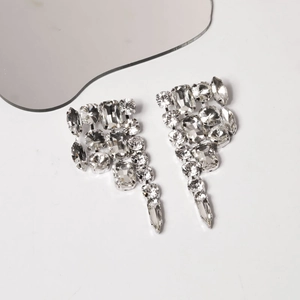 Detailed close-up of sparkling crystal tassel earrings with irregular teardrop rhinestones