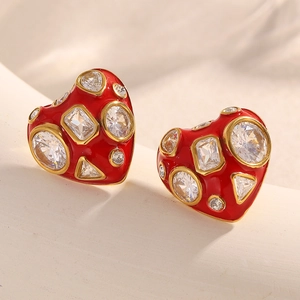 Detailed view of red heart stud earrings in 18K gold plated steel with clear zircons