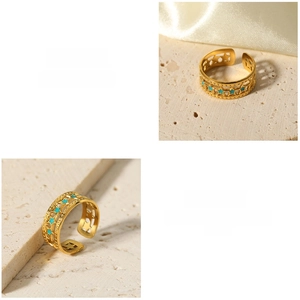 Detail of 18K gold plated stainless steel open ring with green star geometric patterns