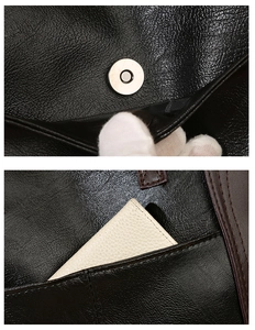 Close-up of magnetic buckle and side pocket on large black pebbled leather tote bag