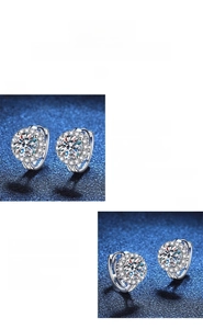 Macro shot of silver sunflower moissanite earrings showing halo design and polished finish