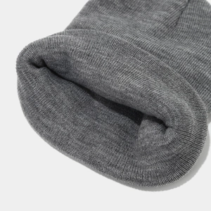 Detailed view of the medium grey knit texture and ribbed cuff on this warm winter beanie