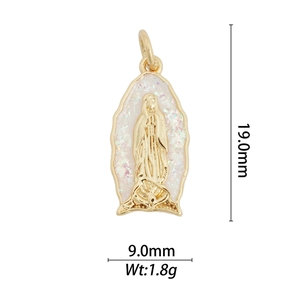 Close-up of 18k gold-plated pendant with white inlay and religious embossed detail
