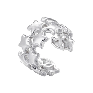 Detail of silver star-shaped ear cuff with open design and minimalist metallic luster