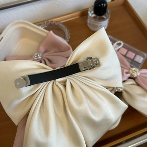 Large cream satin bow hair clip with camellia pearl detail and metal spring clip