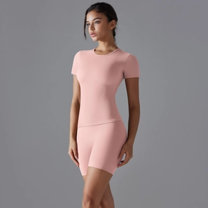 Détail de l'ensemble de yoga rose avec t-shirt cintré et short de sport taille haute