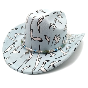 Light blue western cowboy hat with seagull prints and evil eye beaded decorative band