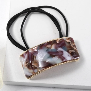 Detail of square acetate hair tie with purple marble pattern and gold metal frame