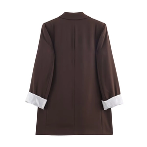 Rear view of brown longline blazer showing white pinstripe lining on folded cuffs