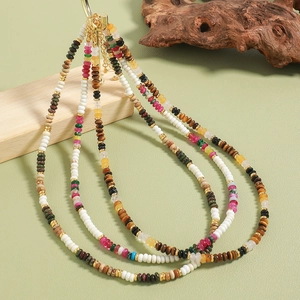 Three-layer bohemian beaded necklace with tiger eye and natural stones on wooden decor
