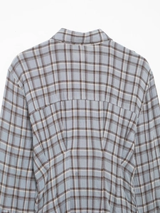 Detail view of the light blue and grey plaid fabric texture on a shirt dress