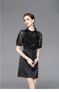 Close-up of black lace patchwork dress featuring heavy beadwork and sequin details