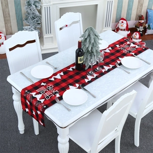 Close-up of red and black buffalo plaid Christmas table runner with festive patterns