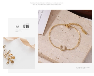 Detail of horseshoe bracelet in gold with sparkling pave-set cubic zirconia stones
