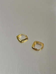 Detailed close-up showing S925 hallmark on gold plated geometric diamond pattern earrings
