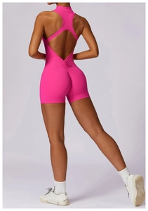 Close-up of bright pink yoga bodysuit featuring an open back and ruched butt-lifting detail