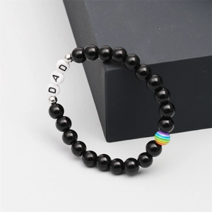 Detailed macro of Father's Day beaded bracelet with DAD letters and rainbow bead