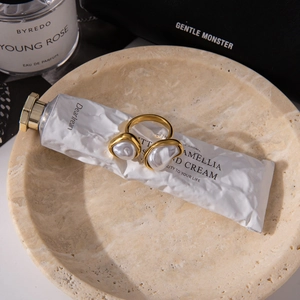 Detailed view of 18K gold plated stainless steel open ring with baroque pearls