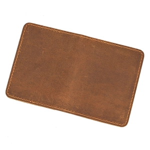 Detail shot of brown crazy horse leather coin purse showing natural texture and stitching