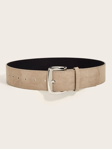 Flat lay of khaki suede wide waist belt with square silver buckle on neutral background