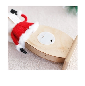 Detail view of the battery box and toggle switch on a Nordic wooden Santa ornament