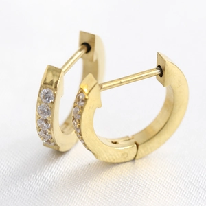 Close-up of gold stainless steel hoop earrings featuring a single row of clear cubic zirconia