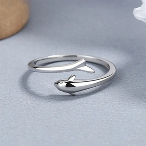 Macro shot of 925 silver dolphin wrap ring with polished mirror finish and open band