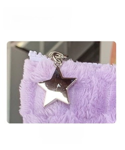 Detail of purple plush pouch showing the star-shaped metal zipper and soft texture