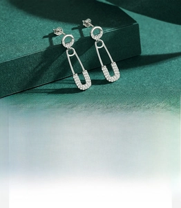 Macro shot of 925 silver safety pin earrings with hand-set 5A cubic zirconia stones
