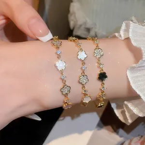 Elegant gold flower bracelet set with white acetate and zircon on a lace background