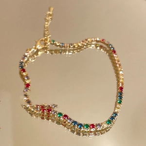 Macro view of gold-plated rainbow cubic zirconia bracelet with adjustable lobster clasp