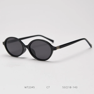 Detail of vintage oval polarized sunglasses with golden striped metal trim on the temple