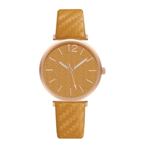 Detail of ginger leather strap with woven texture and rose gold leaf pattern dial