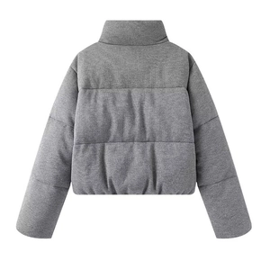 Detail view of grey short puffer jacket showing quilted texture and back stand-up collar