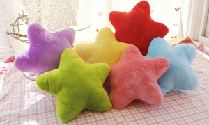 Colorful star-shaped plush pillows in six vibrant colors stacked on soft checkered cloth