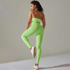 Detail view of fluorescent green ribbed knit fabric on high waist yoga leggings and top