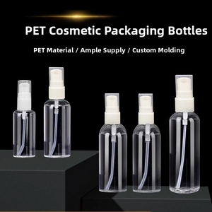 Set of clear PET cosmetic pump bottles with white spray heads on a dark pedestal