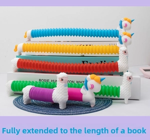 Pop tube unicorn toy stretched to a full length matching a standard book size
