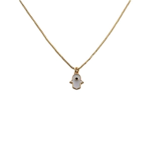Macro view of gold plated Hamsa hand pendant with white enamel and evil eye detail