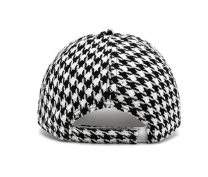 Rear view of vintage black and white houndstooth baseball cap with adjustable velcro closure