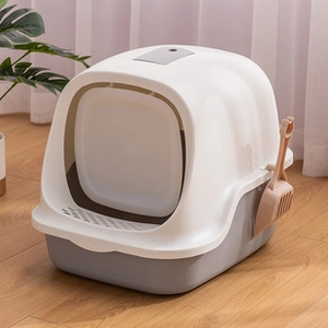 Detailed view of closed cat litter box with gray base and ergonomic brown scooper
