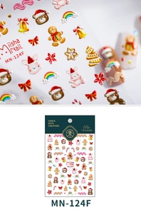 Close-up of Christmas nail stickers with 3D embossed teddy bears and gingerbread men