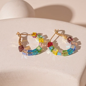 Minimalist gold hoop earrings featuring colorful square crystal glass beads in rainbow colors