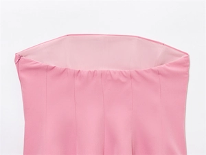 Detail of side zipper closure and multi-panel stitching on pink strapless top