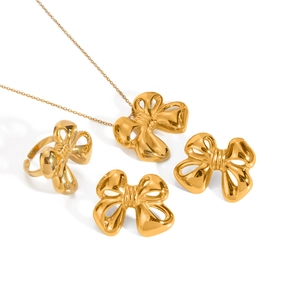 Luxurious gold bow jewelry set featuring a necklace, earrings, and ring in stainless steel