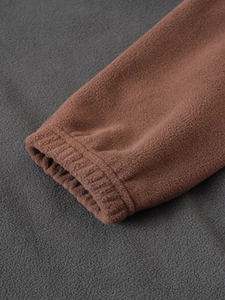 Close-up of elastic cuffs on brown tactical fleece jacket showing high-quality stitching