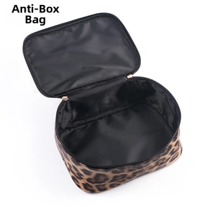 Macro detail of leopard print makeup bag featuring black lining and rose gold zipper