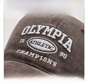 Close-up of vintage embroidery and washed cotton fabric texture on a baseball cap